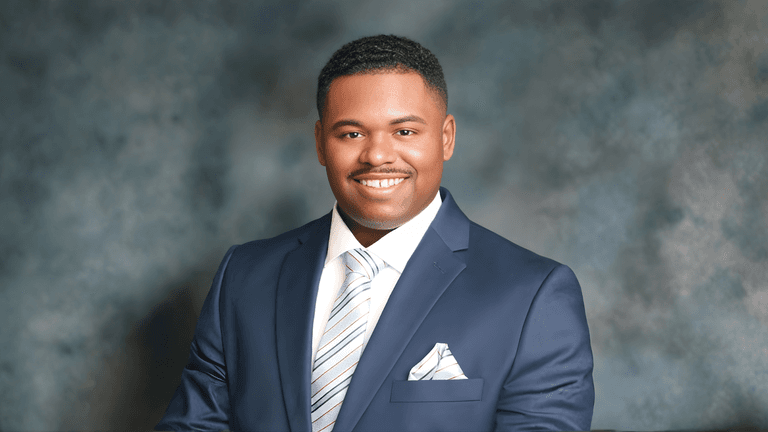 Daniel McDavid, founder of Move Mountains Credit Repair, pictured professionally in a suit, embodying dedication to financial empowerment and credit repair services.