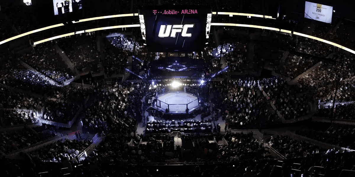 Aerial view of a packed UFC event at T-Mobile Arena with an illuminated octagon