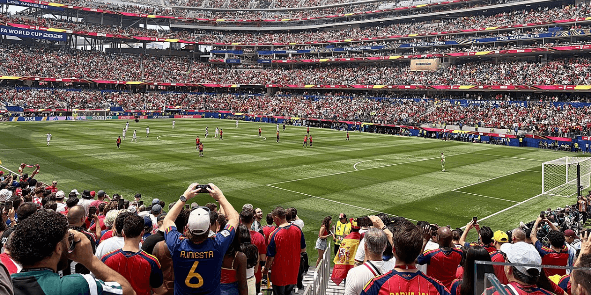 Crowd at a FIFA World Cup match inside a packed stadium with players on the field