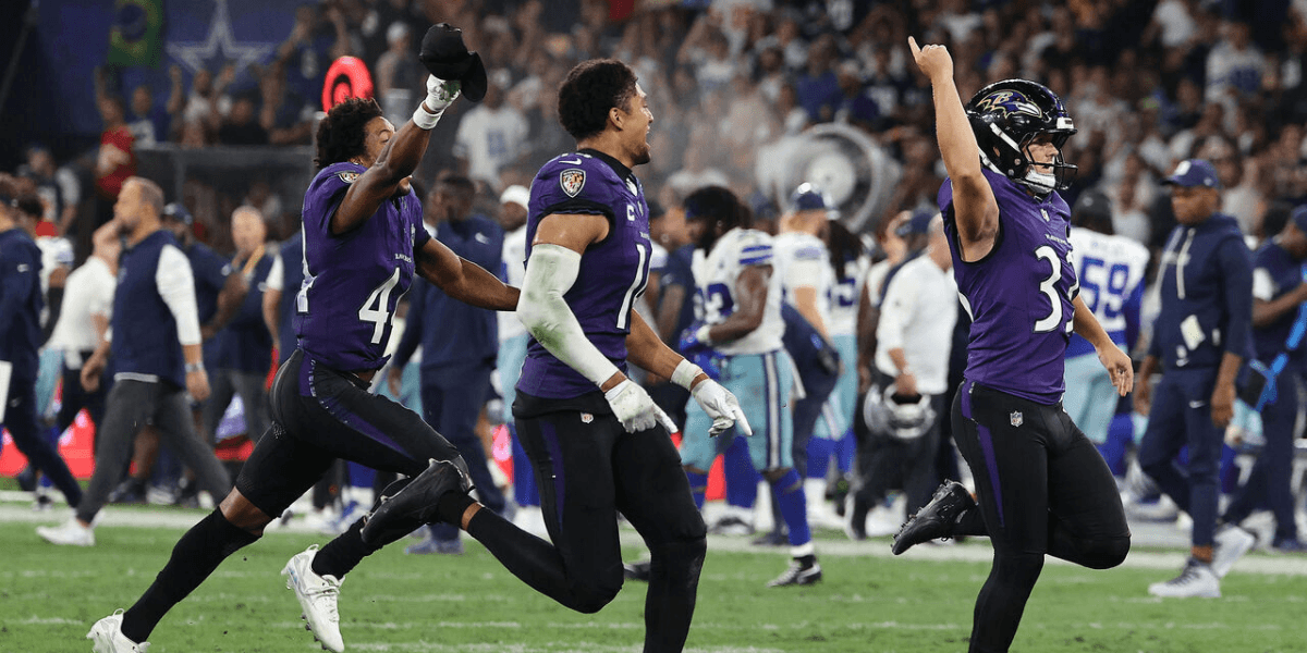 Ravens players celebrate a victory on the field during a football game