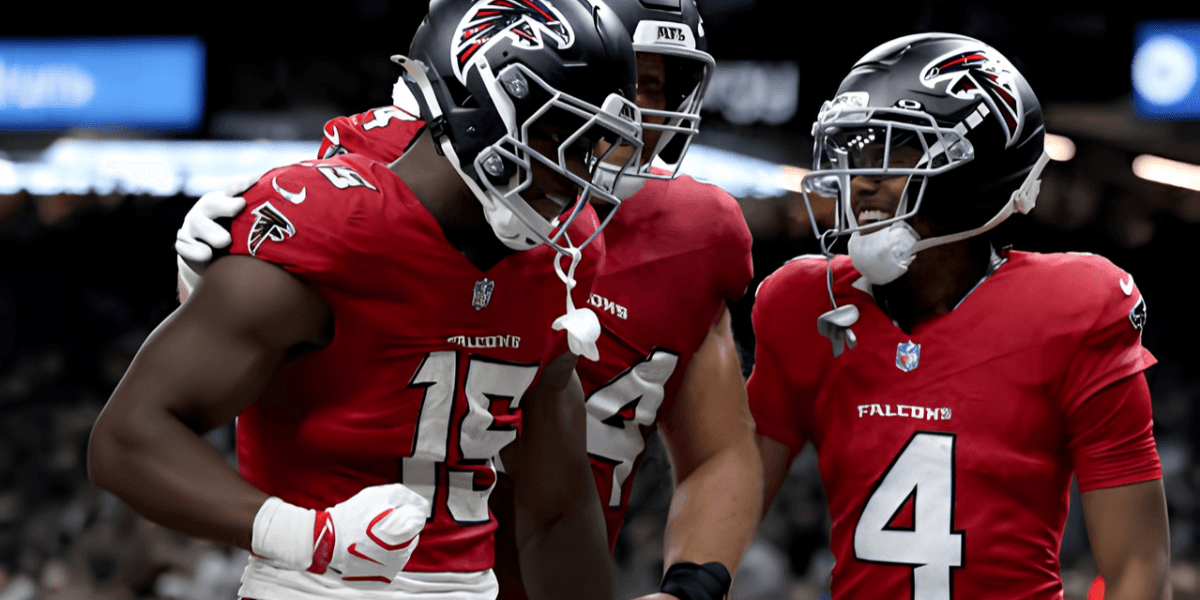 Atlanta Falcons players celebrate a touchdown on the field, wearing red jerseys.