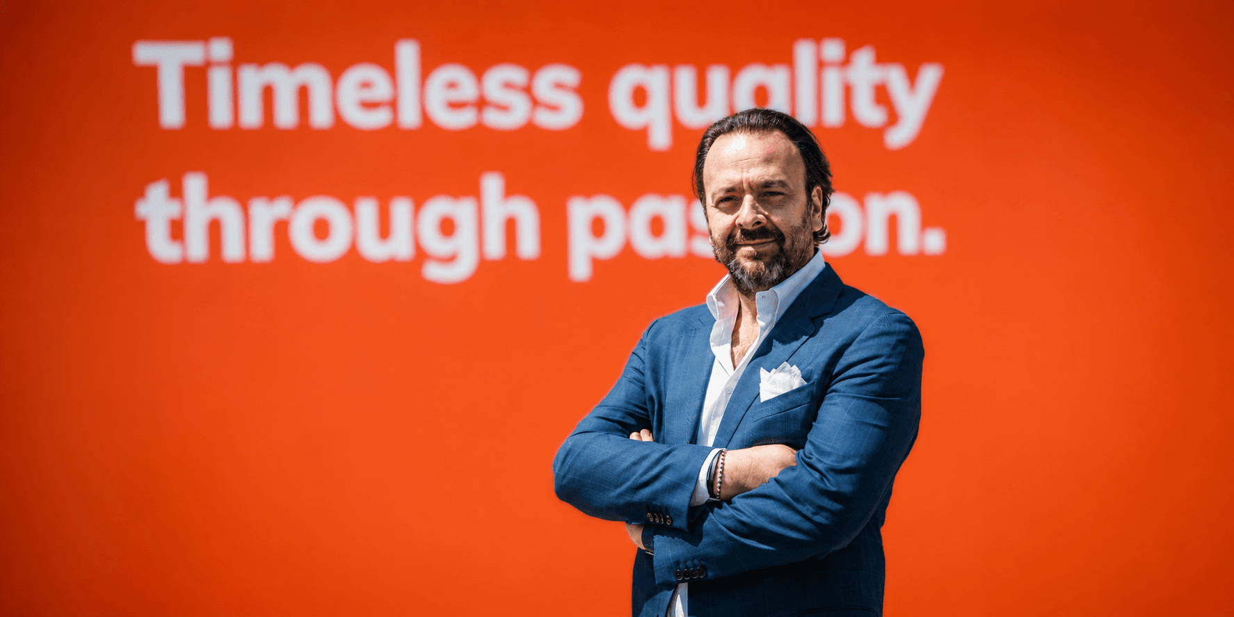 Umberto Maria Cini, Dulevo Sales & Marketing VP, standing before a corporate display.