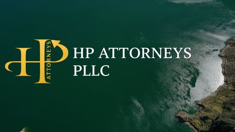 Aerial view of a serene green lake with rugged shoreline. The logo of "HP Attorneys PLLC" is prominently displayed, suggesting professionalism and calm.