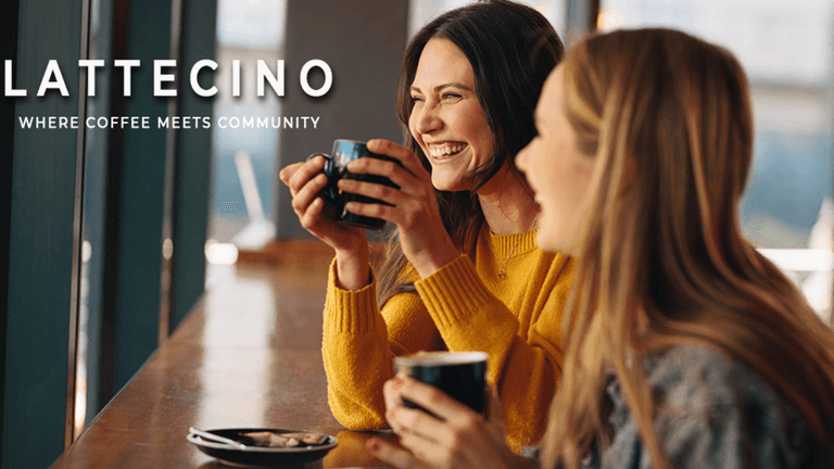 Two women enjoying coffee together, sharing a joyful moment at a café.