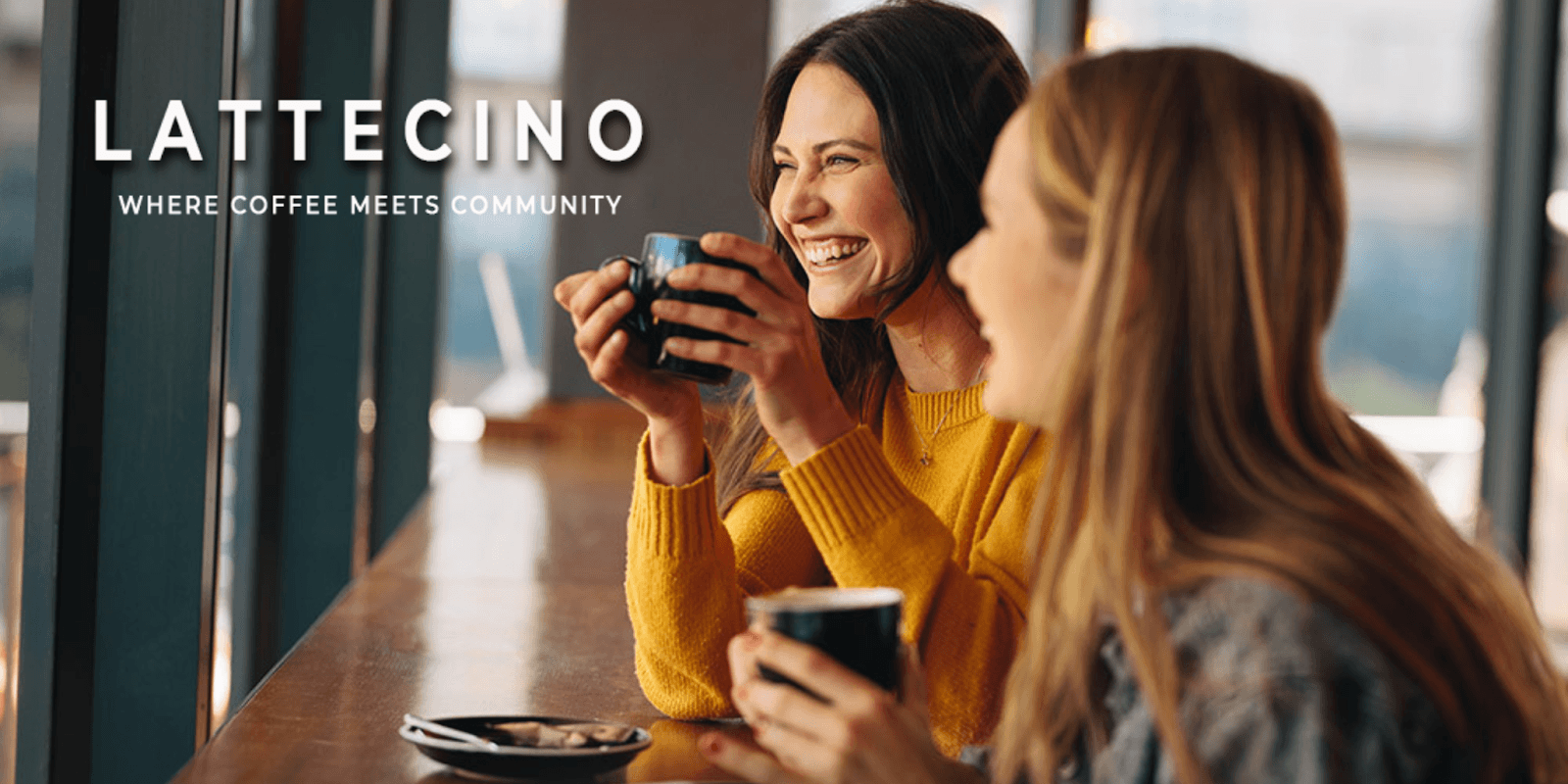 Two women enjoying coffee together, sharing a joyful moment at a café.
