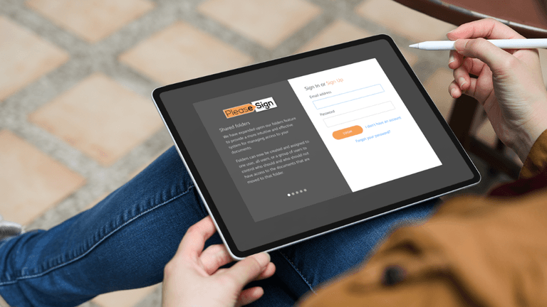 Person using tablet to access PleaseSign digital signing platform with stylus in hand.