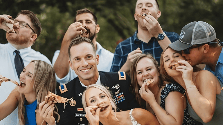 a joyful group enjoying pizza at an event, reflecting Atlanta Pizza Truck’s focus on creating memorable, interactive experiences