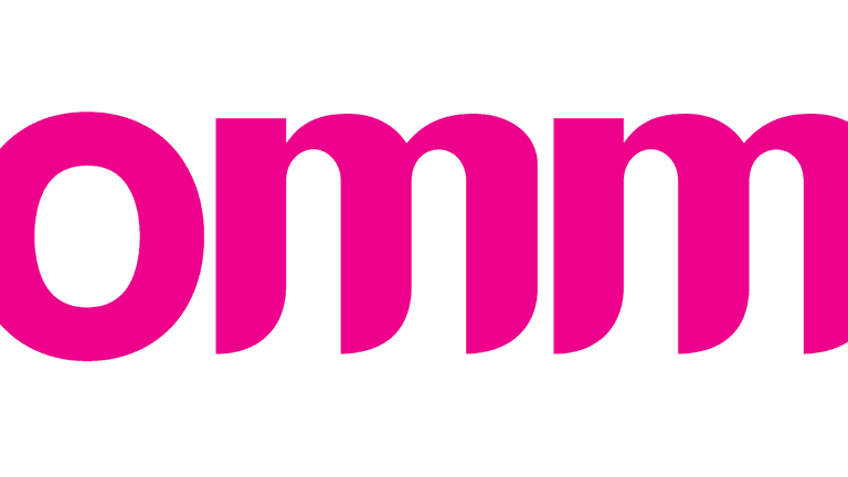 The bold, pink 'OMM' logo representing a brand in a clean, minimalistic style.