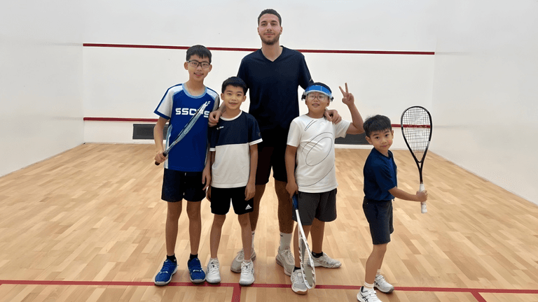 "Ahmed Amr, a rising squash coach, mentoring young players, showcasing his expertise in coaching both juniors and professionals."