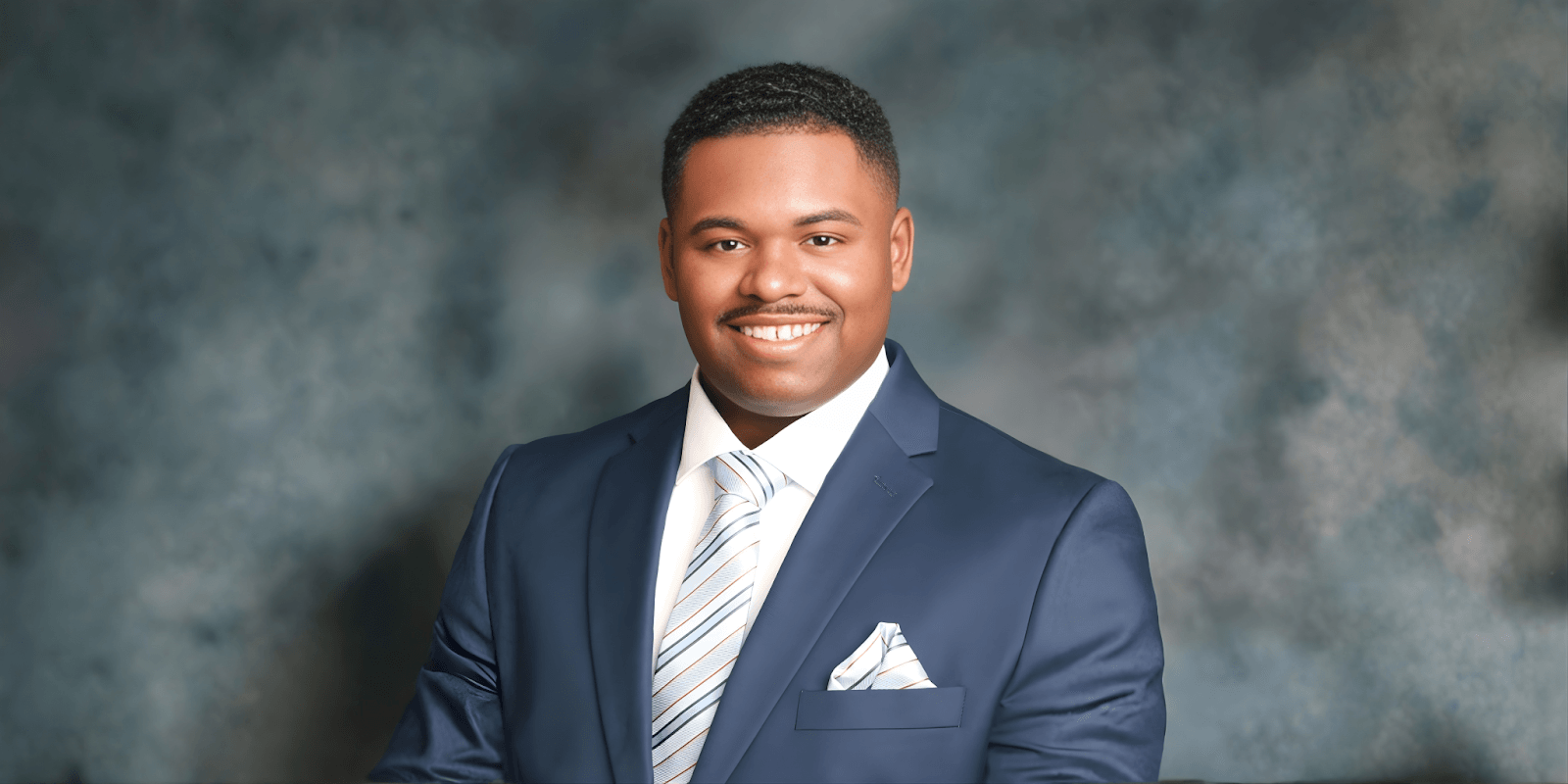Daniel McDavid, founder of Move Mountains Credit Repair, pictured professionally in a suit, embodying dedication to financial empowerment and credit repair services.