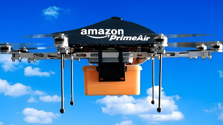 Amazon Prime Air drone flying against a blue sky carrying an orange package