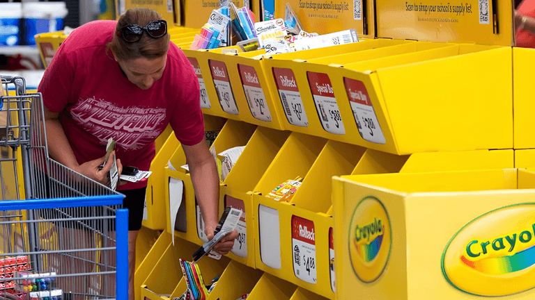 A woman shopping for school supplies at a Crayola display in a store