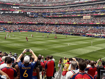 Crowd at a FIFA World Cup match inside a packed stadium with players on the field