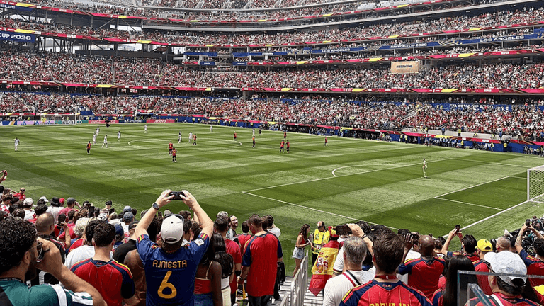 Crowd at a FIFA World Cup match inside a packed stadium with players on the field