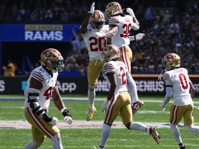 San Francisco 49ers players celebrating a play during a football game in London