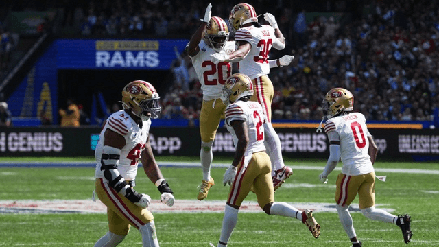San Francisco 49ers players celebrating a play during a football game in London