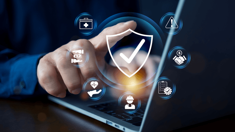 Person using a laptop with security icons and symbols on the screen