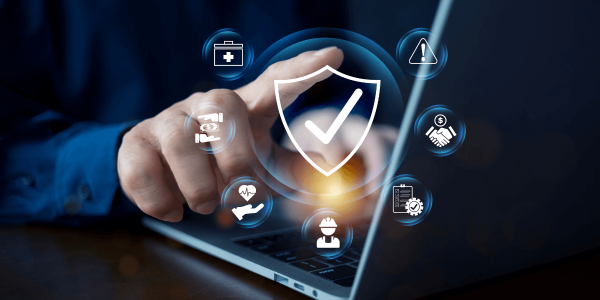 Person using a laptop with security icons and symbols on the screen