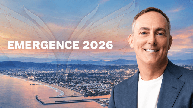 Smiling man in a suit with coastal city skyline and "EMERGENCE 2026" text