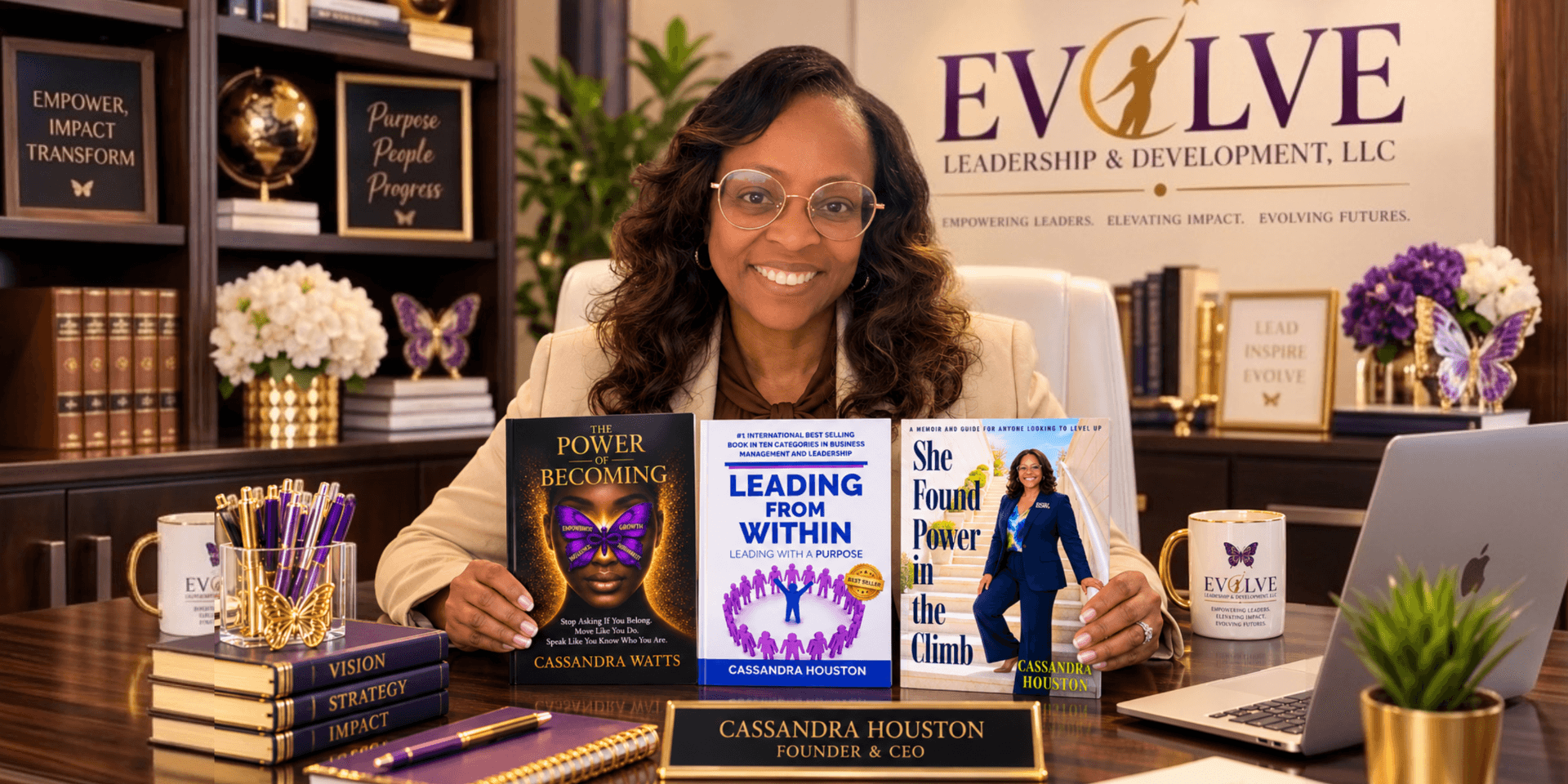 A woman sits at a desk with her books, promoting her leadership development business.
