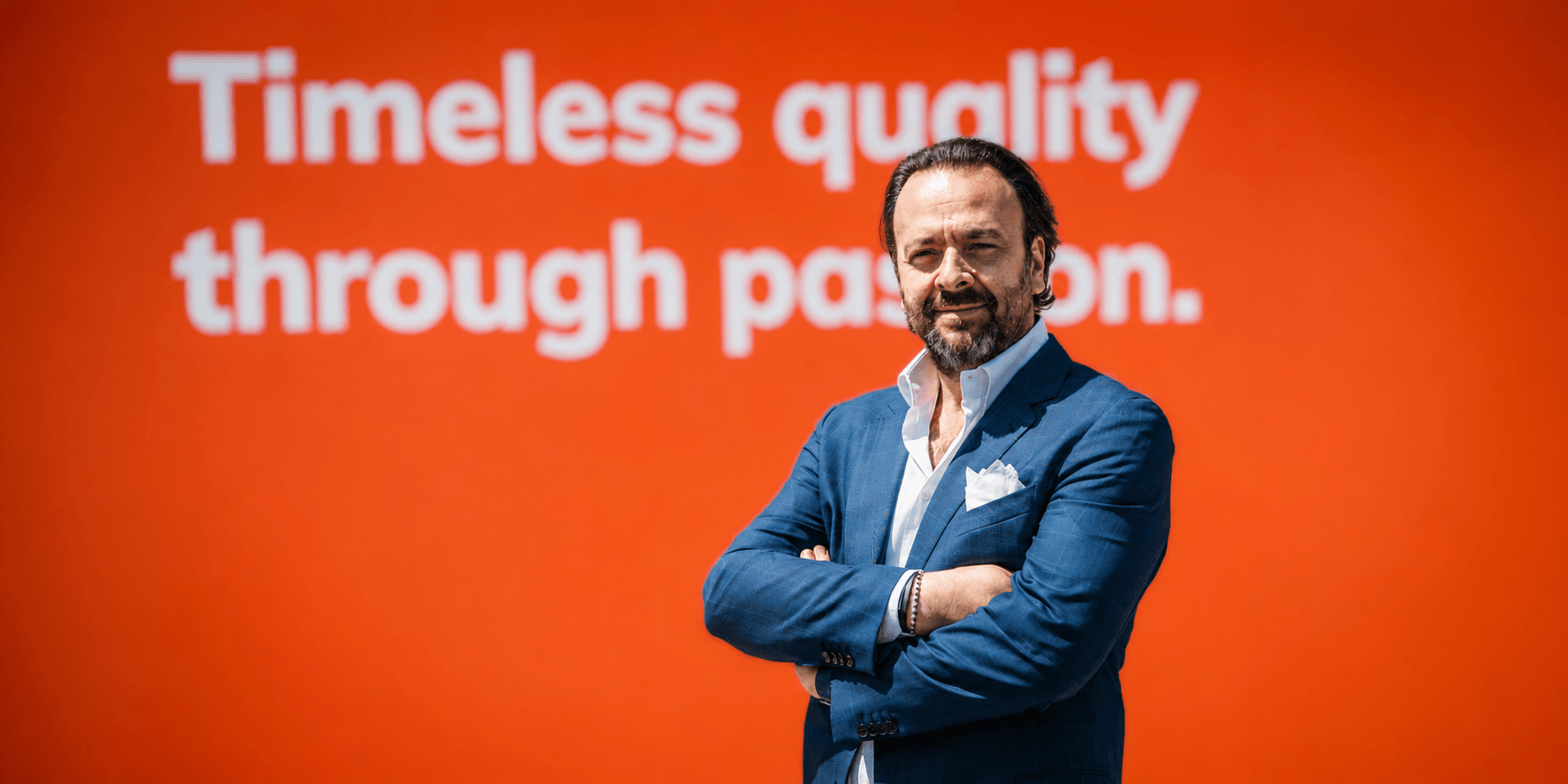 Umberto Maria Cini, Dulevo Sales & Marketing VP, standing before a corporate display.