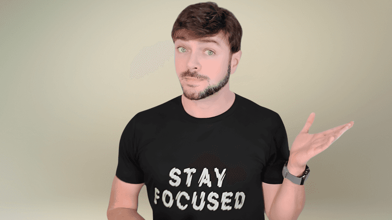 Chris Gibson, holistic esthetician, shares skincare tips in a 'Stay Focused' t-shirt, embodying a natural beauty philosophy.