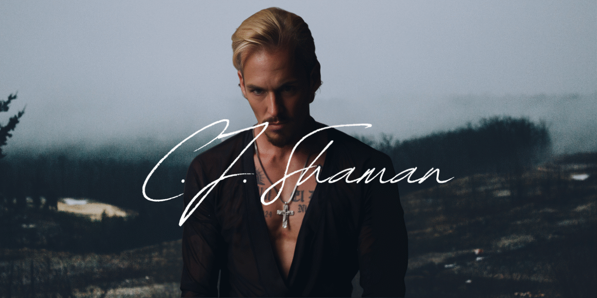C.J. Shaman poses in dark clothing with cross necklace, name stylized across image, misty forest background.