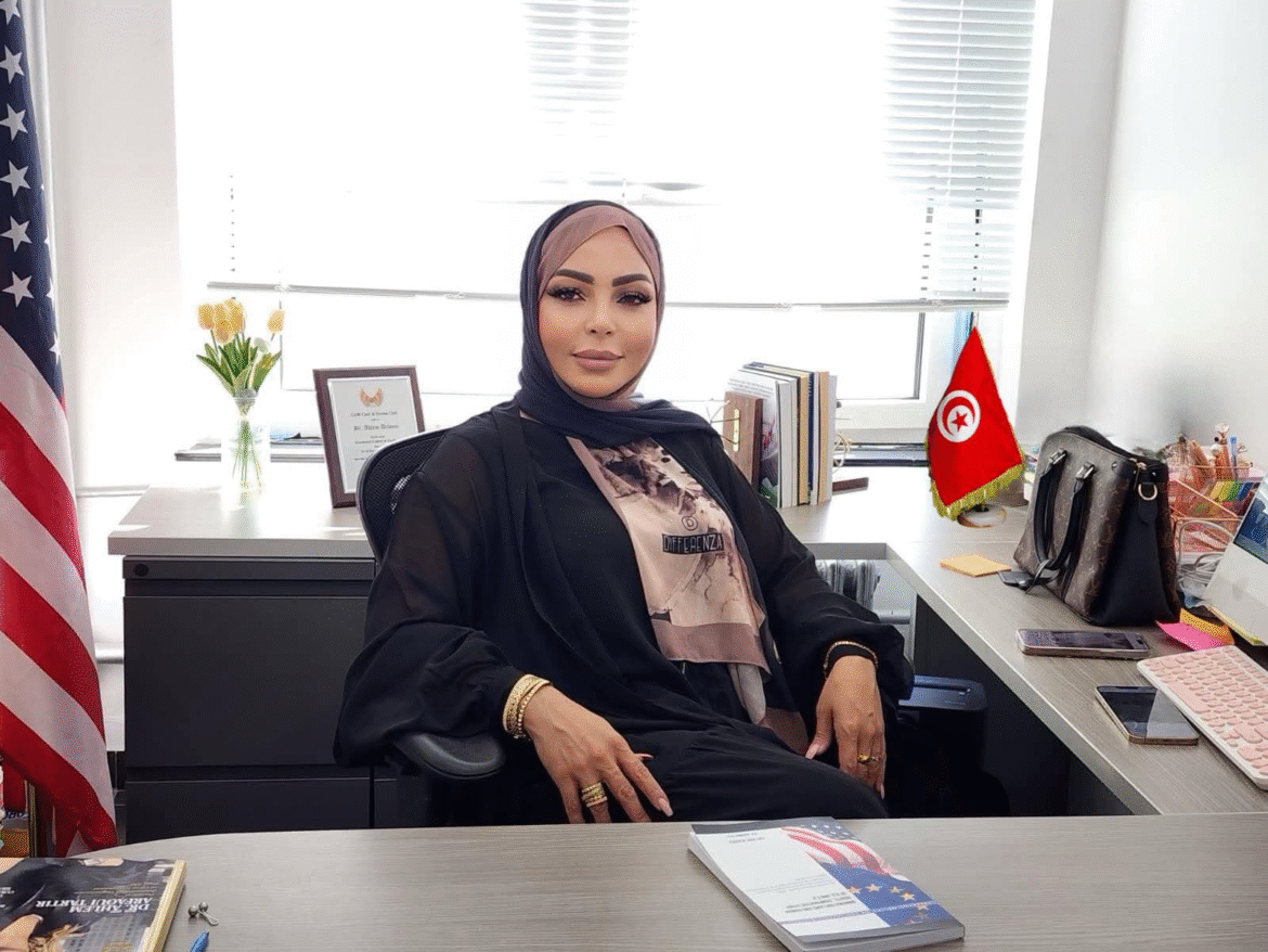 Dr. Ahlem Arfaoui Tartir seated in her office, symbolizing leadership in immigration reform and refugee protection.