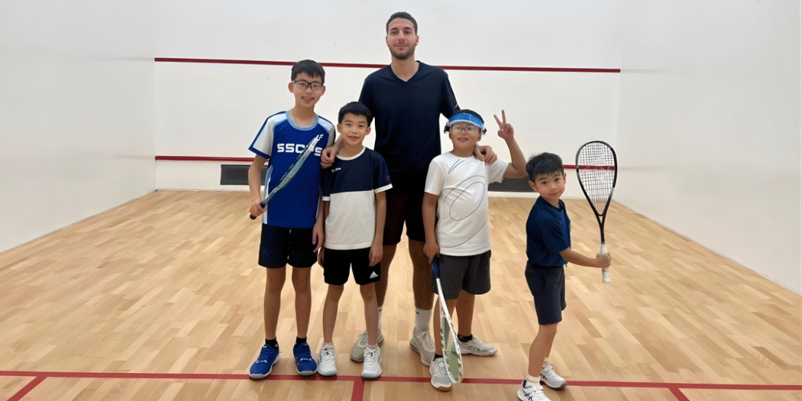 "Ahmed Amr, a rising squash coach, mentoring young players, showcasing his expertise in coaching both juniors and professionals."