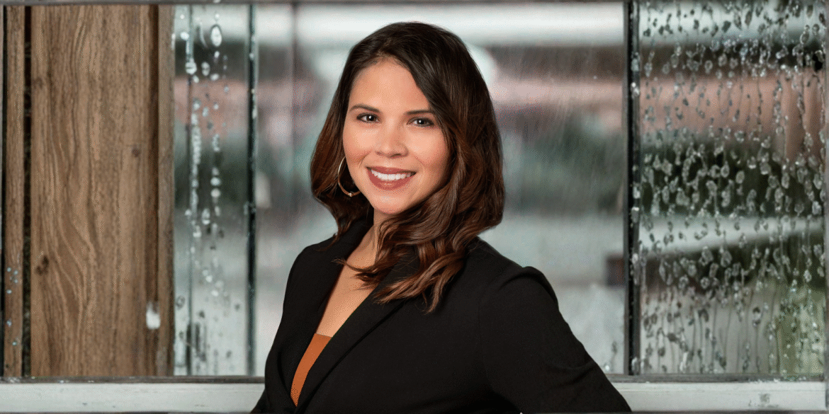 Melissa Crews, founder of Seize the Moment Wellness Coaching, smiling with a rain-covered window backdrop.