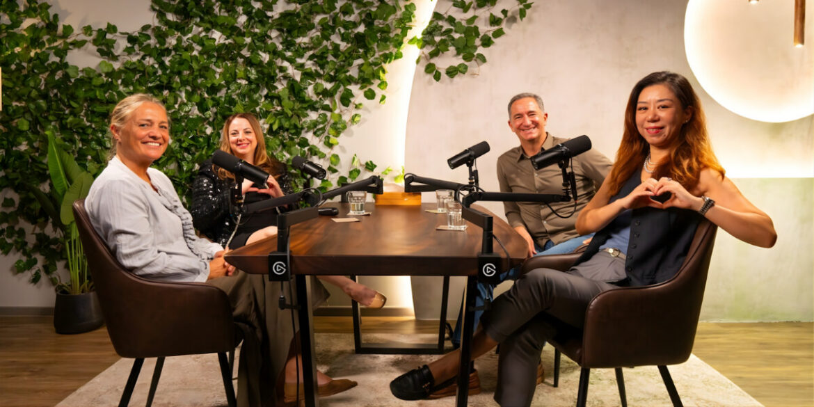 Podcast hosts and guests engage in a warm, empathetic conversation, recording Ella Podcasts about life's hardest moments.