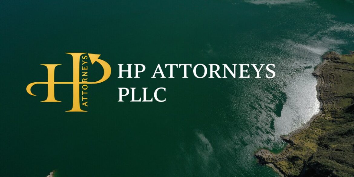 Aerial view of a serene green lake with rugged shoreline. The logo of "HP Attorneys PLLC" is prominently displayed, suggesting professionalism and calm.
